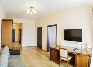 a living room filled with furniture and a tv at Avrora Spa Hotel in Stepan'kovo