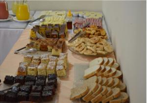 a buffet of different types of food on a table at Pousada Vale do Caparaó in Caparaó Velho