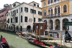 a group of gondolas in a canal next to buildings at San Marco - 2 bedrooms with lift in Venice
