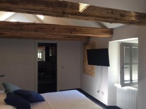 a bedroom with a bed and a flat screen tv at appartamenti e camere Hippy Chic in Domodossola