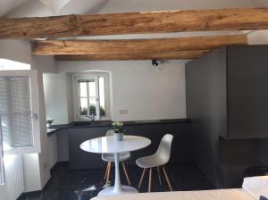 a dining room with a white table and chairs at appartamenti e camere Hippy Chic in Domodossola