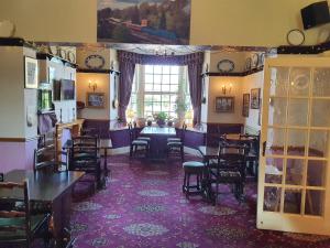 a dining room with chairs and a table and a window at The Goathland Hotel in Goathland