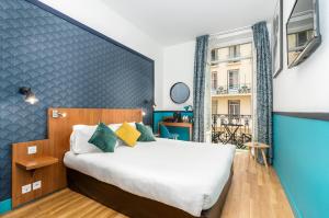 a bedroom with a large bed and a large window at Hotel Nap By HappyCulture in Nice