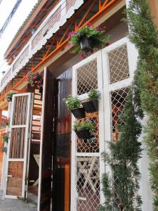 a door with potted plants on the side of a building at Villa Vacay Chiang Mai in Chiang Mai