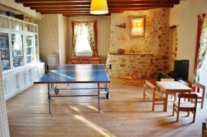a ping pong table in the middle of a room at Les Chambres du Logis du Chatelier in Bressuire