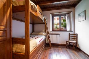a bedroom with two bunk beds and a chair at MONTOLIU de Alma de Nieve in Baqueira-Beret