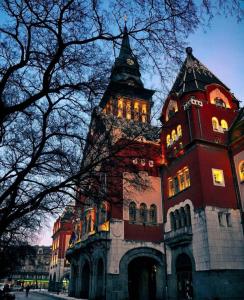 a building with a tower with a clock on it at Smiley 2 - Subotica Centar in Subotica