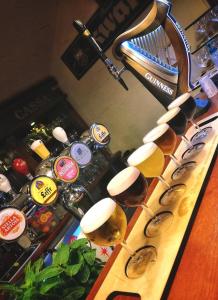 a group of glasses of wine on a bar at Apartman Poirot in Érd