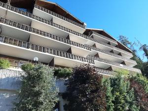 an apartment building with trees in front of it at The fox's family home - Veysonnaz in Veysonnaz