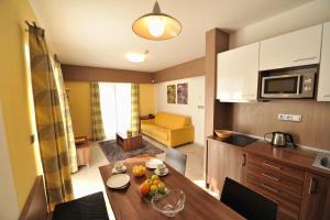 a kitchen and living room with a table in a room at Hotel Jirinka in Dolní Morava
