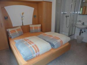 a bedroom with a bed with a shower and a sink at Apartment Antrona by Interhome in Saas-Almagell