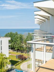 a view of the ocean from the balcony of a building at Seaside Park Apartament Prywatny Kołobrzeg Lokservis - przy plaży in Kołobrzeg