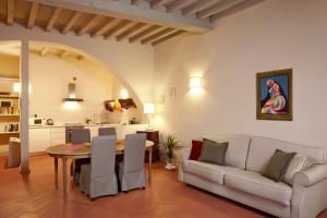 a living room with a table and a couch at My Boutique Home in Florence in Florence