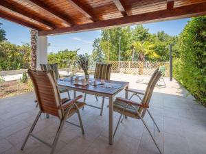 a patio with a table and chairs on a patio at Holiday Home Natali by Interhome in Njivice