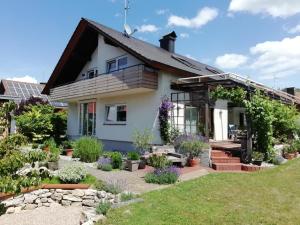 a house with a garden in front of it at Ferienwohnung SOLADOM in Efringen-Kirchen