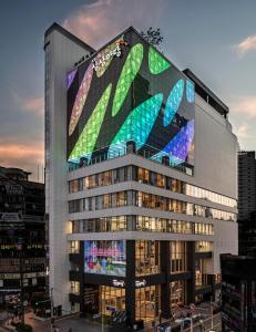 a building with a large painting on the side of it at Sangsang Stay Busan in Busan