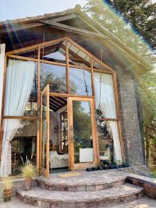 a house with a large glass door and stairs at Casa Arrayán in Santiago