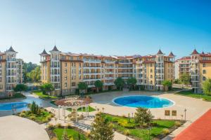 an apartment complex with a large swimming pool and buildings at Royal Sun Apartments in Sunny Beach