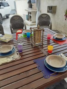 a wooden table with plates and bowls on it at Casa Spina in San Giovanni Teatino