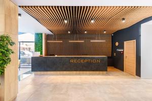 a lobby with a reception desk in a building at Avenue Hotel Deluxe in Burgas City