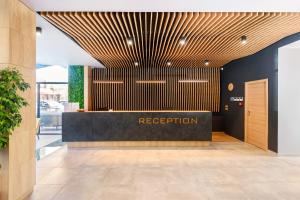 a lobby with a reception desk in a building at Avenue Hotel Deluxe in Burgas