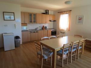 a kitchen with a dining room table and chairs at Holiday Villa Lake Lipno in Lipno nad Vltavou