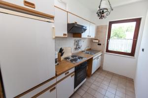 a small kitchen with white cabinets and a sink at Villa Lesic in Dramalj