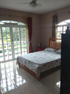 a bedroom with a bed and sliding glass doors at Hostel Da Ilha De Sao Francisco Do Sul in Marechal Luz