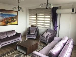 a living room with a couch and two chairs at Konaklar Apart Premium in Trabzon