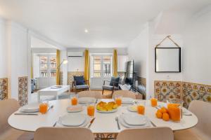 a dining room with a white table with fruit on it at WHome Charming and historical apartment in Santa Justa in Lisbon