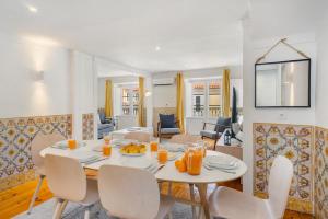 a dining room and living room with a table and chairs at WHome Charming and historical apartment in Santa Justa in Lisbon