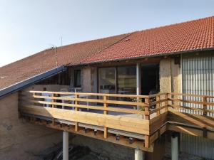 a wooden deck on the side of a building at Appartement 52m2 - Location vacances Vosges in Belmont-sur-Buttant