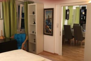 a room with a bedroom and a dining room at In the Heart of the Island in Lindau