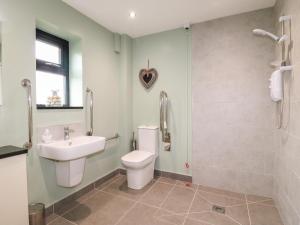 a bathroom with a toilet and a sink at The Coach House, Bank Top Farm in Ashbourne +22 photos