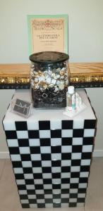 a black and white table with a jar filled with coins at Milano Dreams in Milan