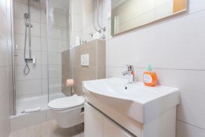 a bathroom with a sink and a toilet and a shower at Apartments & Rooms Alagić in Makarska +48 photos