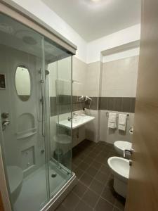 a bathroom with a shower and a sink and a toilet at Pansini Hotel Residence in Badolato