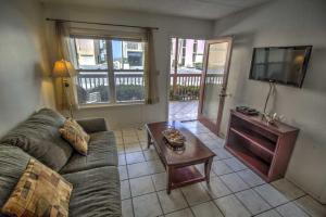 a living room with a couch and a coffee table at SURFSIDE II 107 condo in South Padre Island
