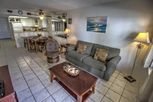 a living room with a couch and a table at SURFSIDE II 107 condo in South Padre Island