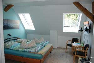 a bedroom with a bed with blue walls and windows at Gästezimmer Hencke in Echem