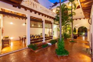 
a large room with a lot of plants in it at Hotel Quadrifolio in Cartagena de Indias
