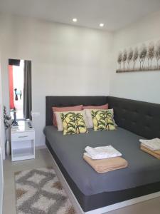 a bedroom with a couch with pillows on it at M & M White Luxury in Paralia Katerinis +69 photos
