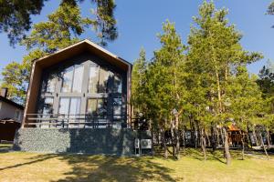 a house with a large window in a yard at Dachi Holiday home in Volzhskiy