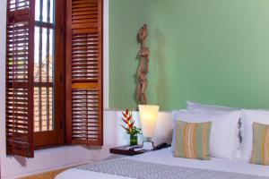 Ένα ή περισσότερα κρεβάτια σε δωμάτιο στο Hotel Quadrifolio