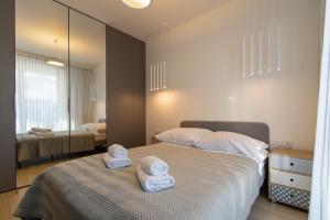 Posteľ alebo postele v izbe v ubytovaní VIP Apartamenty Butikowa