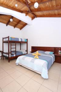a bedroom with two beds and a wooden ceiling at Santagua Termas de Chachimbiro in Urcuquí