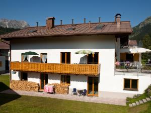 a large white house with a balcony with a deck at Haus Ricarda in Lech am Arlberg
