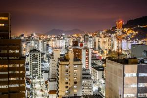 a city skyline at night with tall buildings at Rede Andrade Cecomtur in Florianópolis