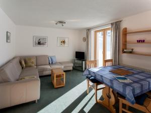 a living room with a couch and a table at Haus Ricarda in Lech am Arlberg