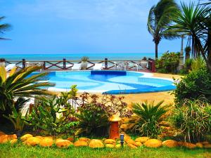 a swimming pool with a fire hydrant in front of it at Pousada do Mar in Ilhéus